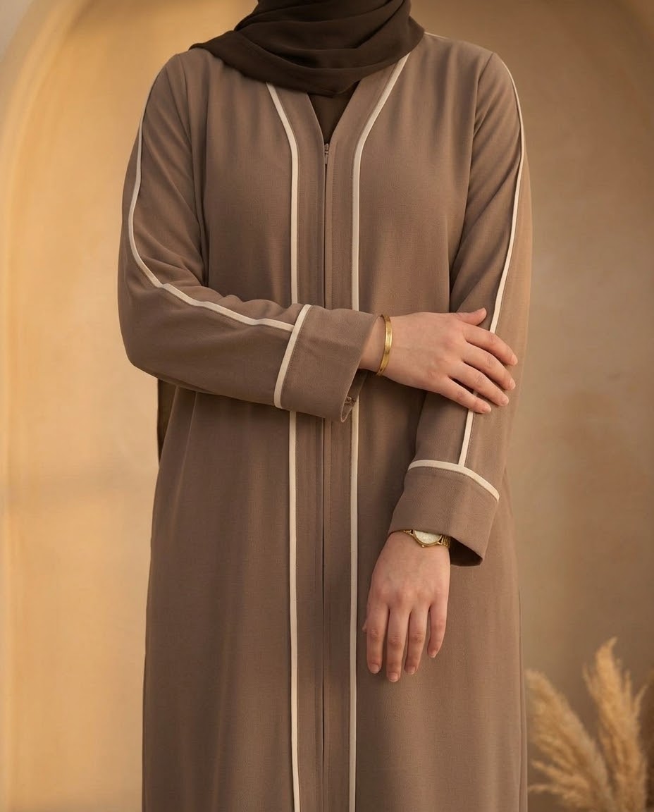 Mocha abaya showing cream piped front and sleeves